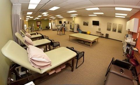 The physical therapy gym, treatment beds have curtains for privacy.