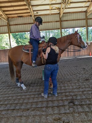 Saddling up on Pepper with help from Nola.