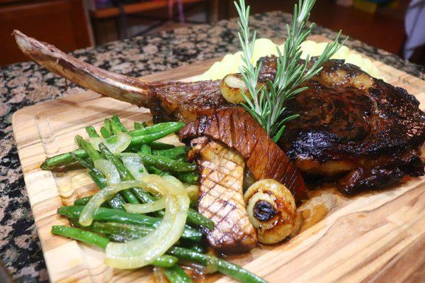 Herb, Garlic & Balsamic Infused 2 LB Tomahawk Ribeye Steak Rosemary Scented Whipped Yukon Mashed Potatoes
 French Green Beans & onions