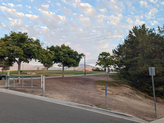 View of the parking lot and back end of the park from the sidewalk