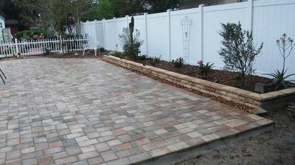 To big patio' s with custom pavers and raised planters build in to match the stone work