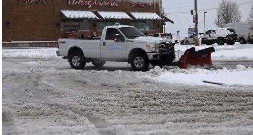 Plow truck servicing a local business