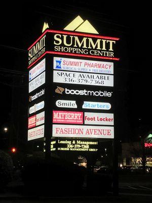 Pylon sign at night at Summit Shopping Center