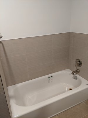 New bathtub and new tiles.