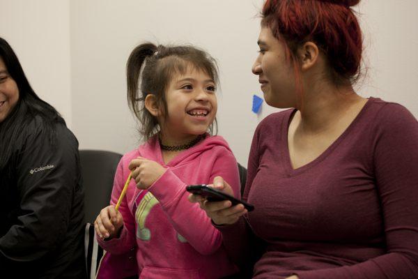 Sisters having some fun in the dental waiting room while waiting for their mom