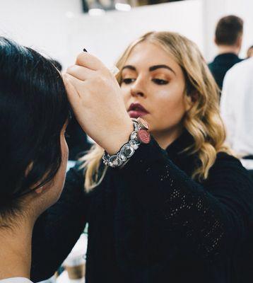 Natalie R doing makeup at New York Fashion Week