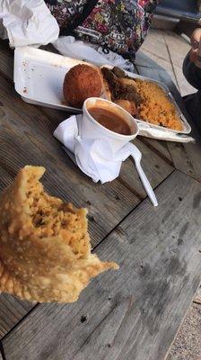 Chicken empanada, potato ball, yellow rice and stew, beans