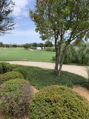 View from patio looking toward putting/chipping greens and covered hitting  area.