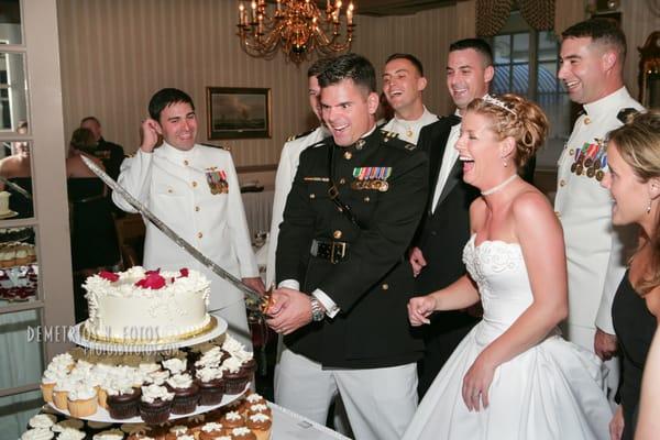 Marine and his Bride prepare to slice the wedding cake.