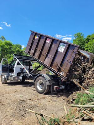 Our fleet in action, dumping one of the many things we can haul away for you!