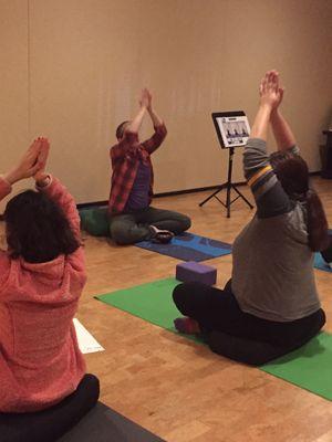 Hannah Gould teaching students in the Friday night yoga for Autism class at TriYoga in Waltham, MA.