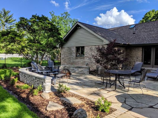 New bluestone patio with dining and fire pit areas.