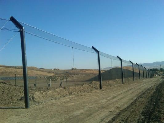 Landfill: trash containment barrier