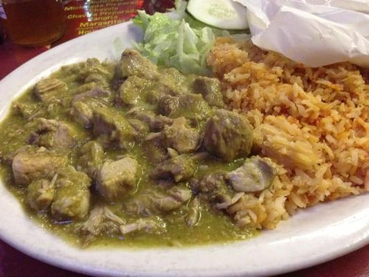 Chile verde served with handmade tortillas beans and rice.