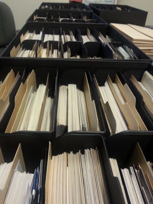 No photo organization project we can't do! Here's 12,000 photos in archival boxes after we scanned and organized them.