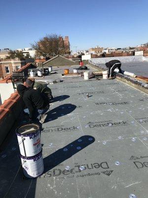 Roof in progress. 
Complete roof replacement with insulation, 1/2 " cover board. Stucco of parapet walls after complete removal.