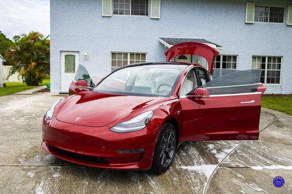 Simple wax detail on this beautiful Tesla with white interior and candy red paint job