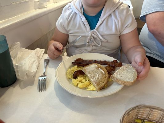 Kids scrambled eggs and toast. Added a side of bacon.