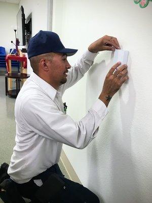 Ramon installing a new air conditioning sensor.