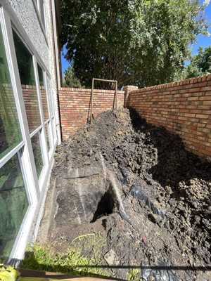 Excavation due to underground pipe leak. Tore up backyard and was never properly put back together.