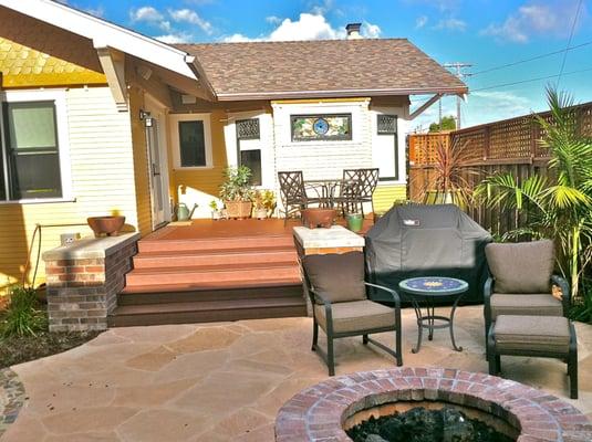 3oth St. exterior hardscape with recycled pvc decking flagstone patio with firepit