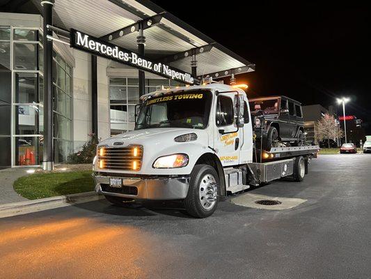 Towing a G wagon on a flatbed tow truck