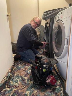 Larry working on washing machine