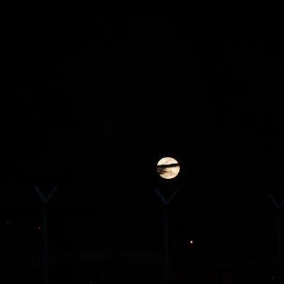 Full moon hiding behind clouds