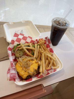 Cheeseburger on a pretzel bun and fries