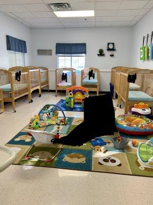 The infant room. That thin rug is the only “safe” play space for the babies that aren’t mobile. Babies often are hurt on the rug and tile.