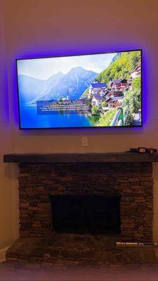 TV INSTALL WITH FLAT BRACKET OVER FIREPLACE.