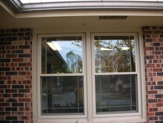 Installed beige double hungs with Prairie grid pattern. Grids are between glass