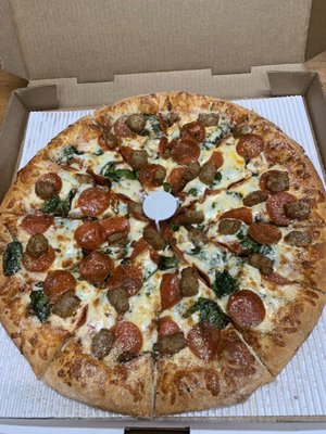 Delicious pepperoni, Italian Sausage and fresh Spinach Pizza