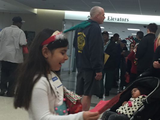 Christmas caroling and passing out holiday gift bags to veterans at the Los Angeles Veterans Affairs hospital.