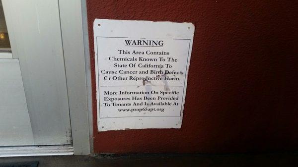 WARNING signage outside of the apartment building