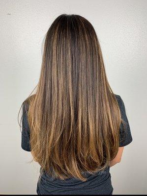 Caramel balayage beautifully brightens up this chocolate brown hair.