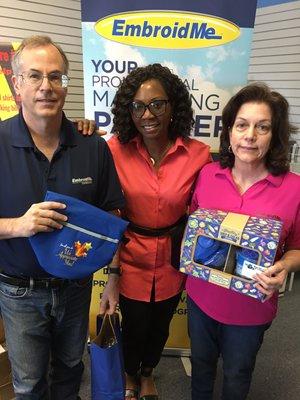 Maude and Dan receiving gifts and an award from Ms. Anita Hilaire.