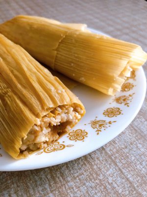 Tamales de rojas, with Mexican cheese and a spicy sauce