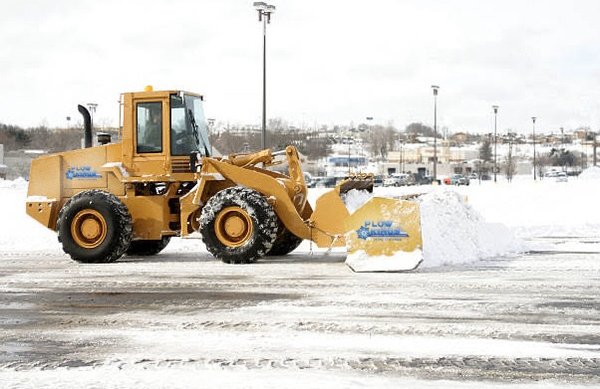 Larger loader pushing snow