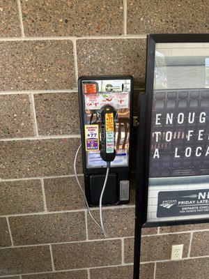 An actual pay phone with dial tone.