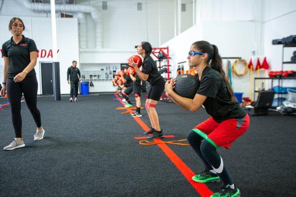 Young athletes train for sports performance on the main floor at Redline Athletics Ventura