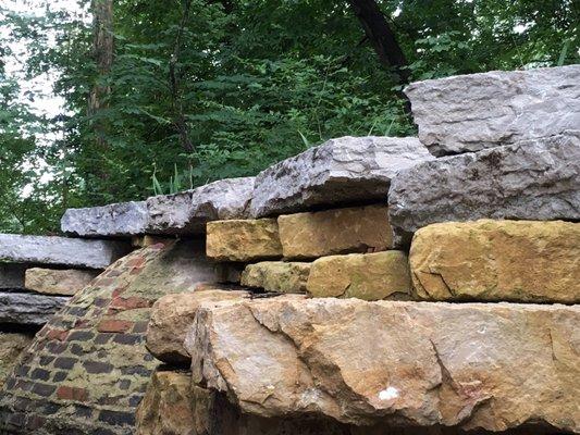 Retaining wall and exposed cistern at the Little Loomhouse