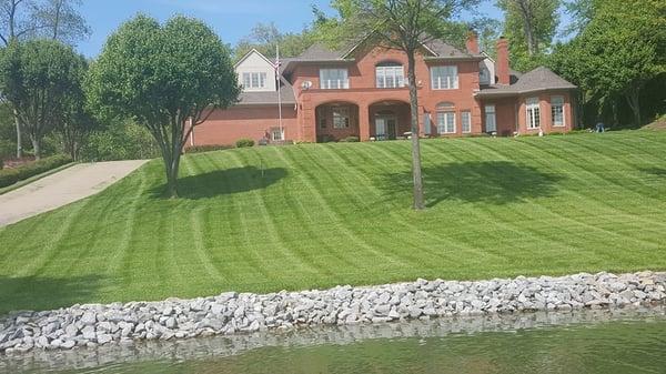 Lake house on Kentucky Lake. We installed landscaping, irrigation, sod, hard scapes, drainage, and provide maintenance.