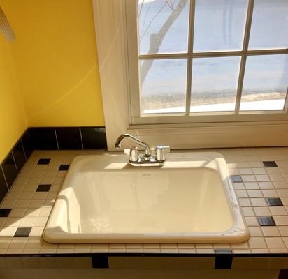 This is the after photo of a new Kohler cast iron laundry sink and faucet.