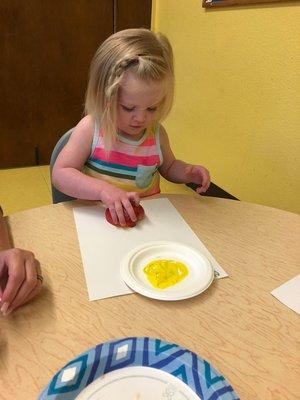 Apple painting is a fun activity for toddlers.