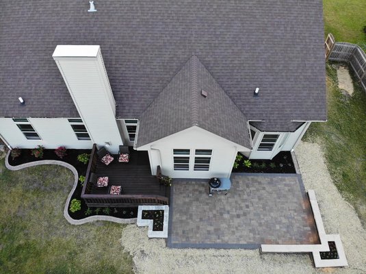 Paver patio with raised garden beds and brick edging