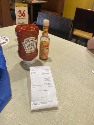 Tables stocked with ketchup and cholula sauce