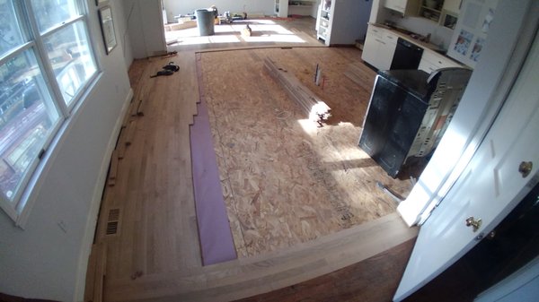 Kitchen floor job with open floor-plan, during installation