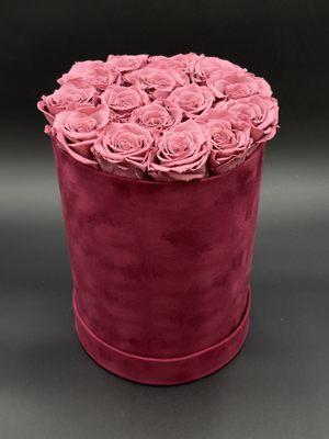 Pink preserved roses in a velvet flower box