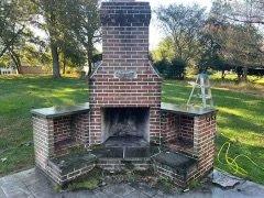 Before picture of same patio and fireplace we soft washed and power washed.